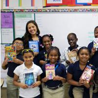  Kathryn Ling &#039;11, upper left, a Teach for America corps member and founder of Light in the Attic, with her fourth-grade class and their current &quot;reads&quot; at Hazlehurst Pre-K-8 School in Mississippi.