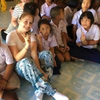  Sofia Aumann ’19, center, spent part of her summer on a service trip to Thailand, where she studied the issue of sex trafficking. She also worked in this school in Chiang Rai where group members taught English lessons, danced, and played with the kids.