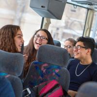  Students laughing on a bus