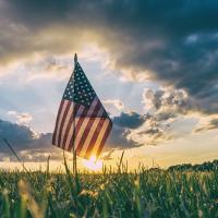  Small American flag backed by sunset
