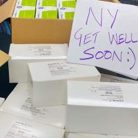  Boxes of donations with a sign saying &quot;NY Get Well Soon&quot;