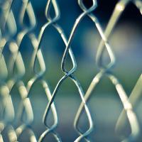  A chainlink fence on a blue background