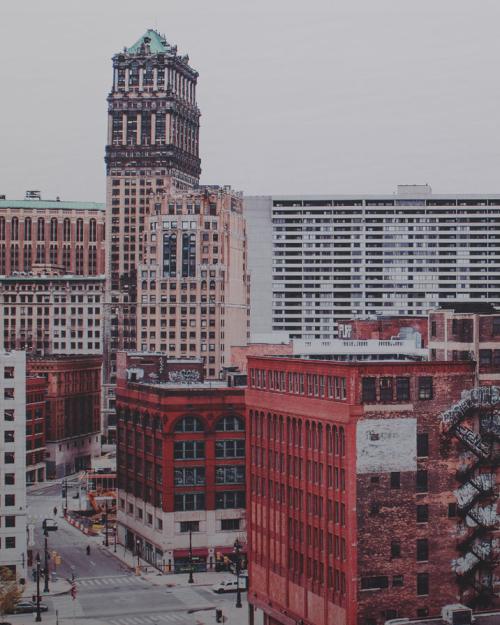 A cityscape with tall buildings and smoke coming from a building