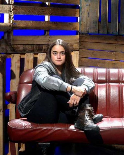 Person sitting on a car seat on a stage set