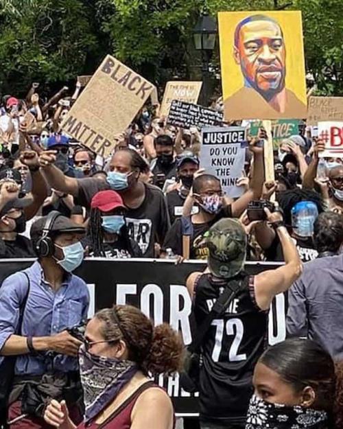 Crowd of people holding signs