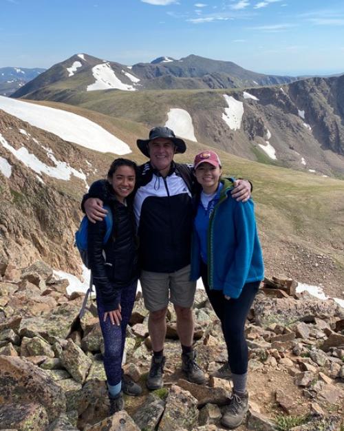 Three people in the mountians
