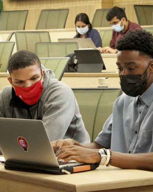 students working together on a computer