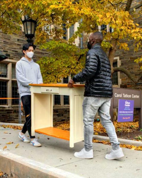 students moving furniture