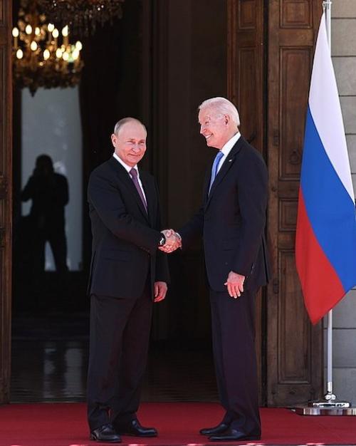 Two people in suits shake hands