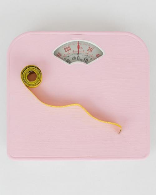 Pink bathroom scale and measuring tape