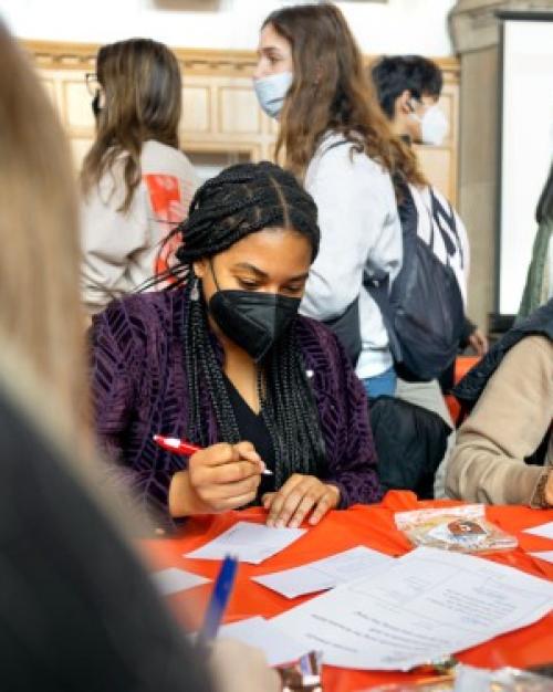 people at a table writing on cards