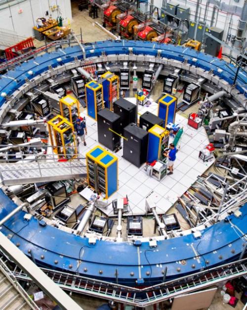 Looking down into a large scientific facility dominated by a blue ring the size of an auditorium