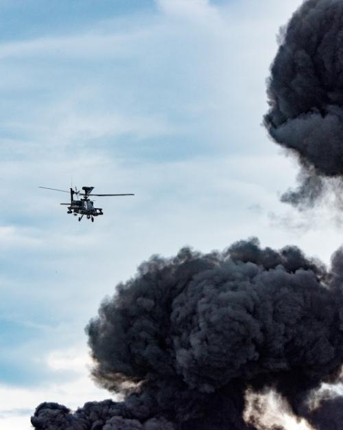 Helicopter flies toward a black cloud