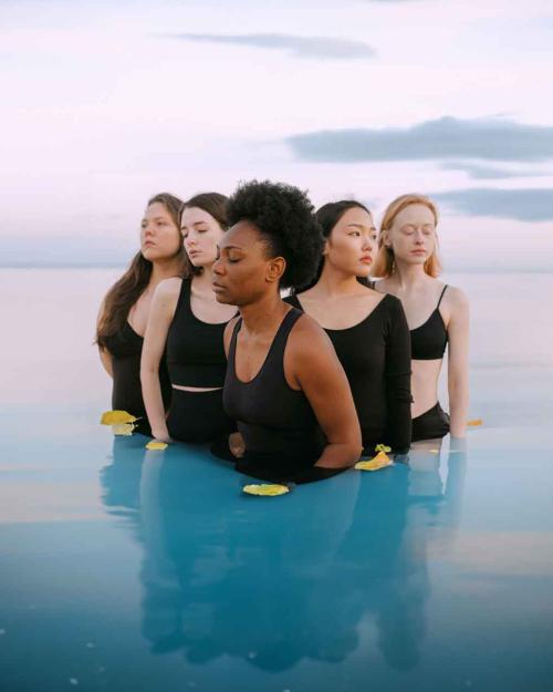 five women standing in water