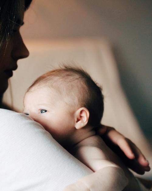 Person holding a newborn