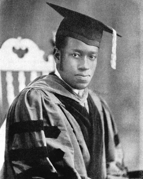 		Elbert Cox: a black and white portrait of a person wearing doctoral regalia
	