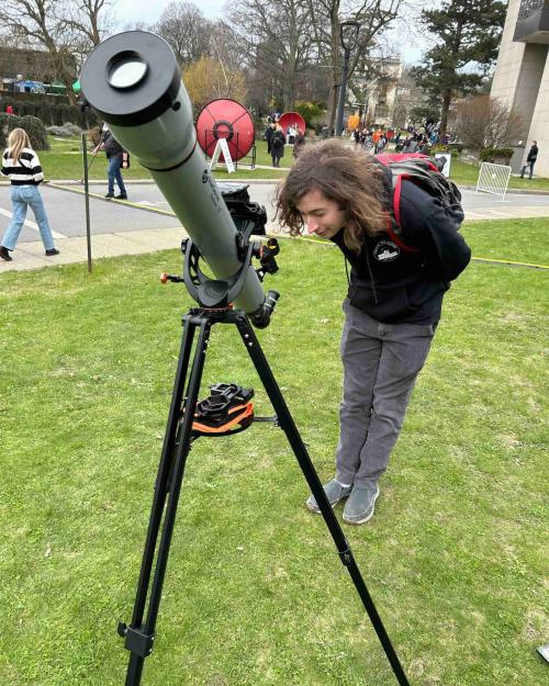 a person looking through a telescope