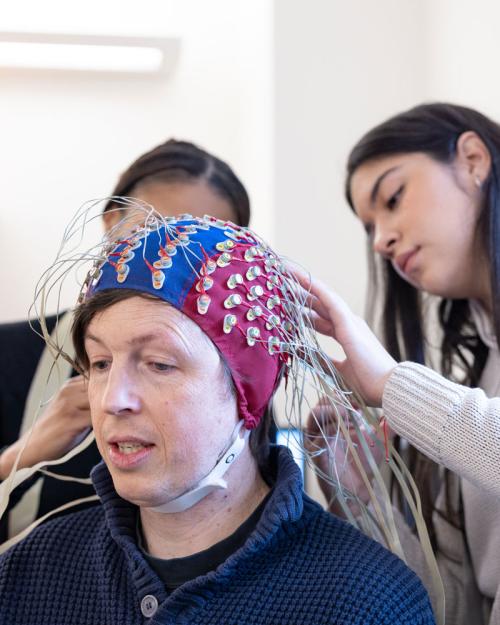 		students place EEG nodes on a study participant
	