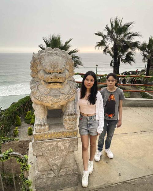 Two people standing by a monument