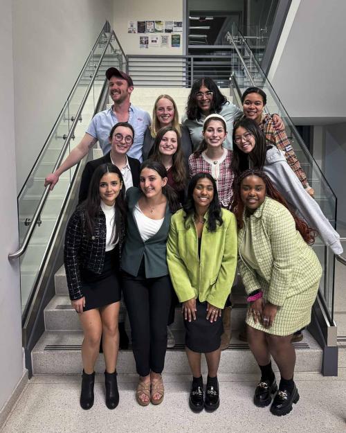 a group of people standing near a stairway