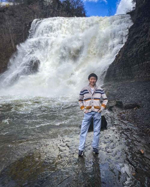 person in front of a waterfall