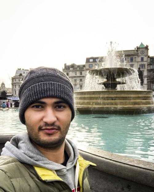 person standing by fountain