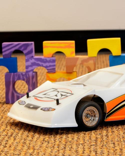 Toy car in front of colored blocks