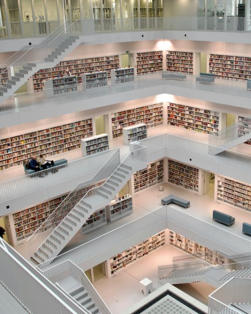 Very large, multi-tiered room lined with shelves of books