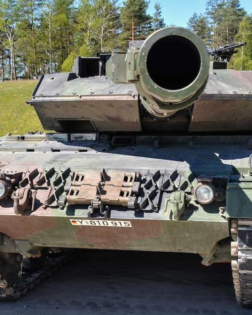 		A military tank up close, with a view directly into the muzzle of its gun
	