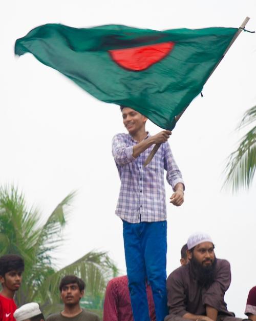 		Person waving the green and red flag of Bangladesh
	