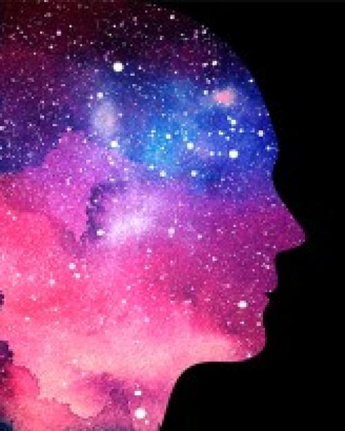 		Fantastilcal ilustration showing a silhouette of a human face in pink, purple and blue celestial light populated by stars
	