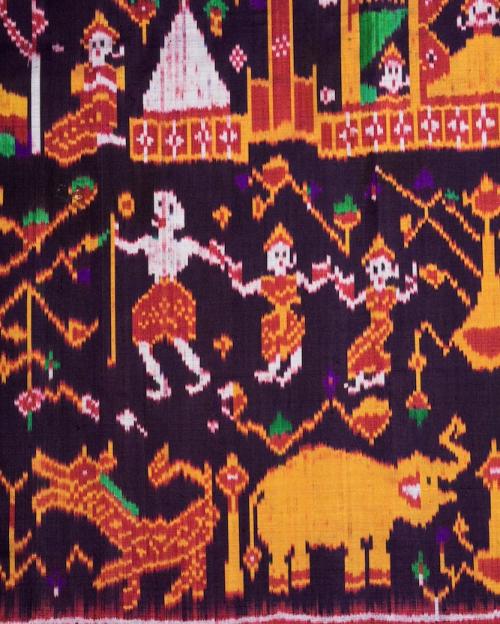 		Detail of a woven cloth showing figures dressed in red and yellow
	