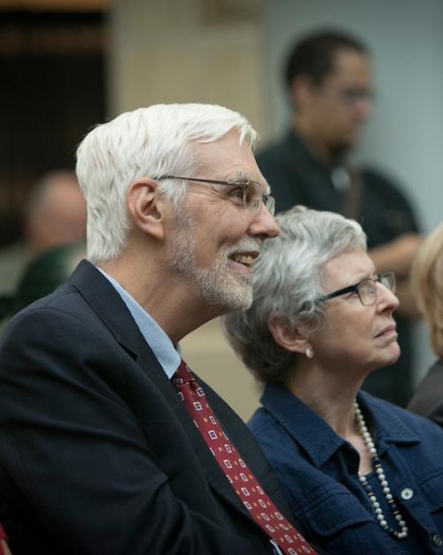 Person in profile; he's part of an audience