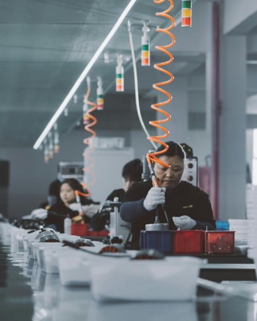 		Line of people working in a factory
	