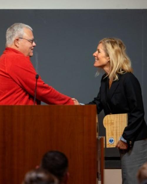 		Person accepts an award at a podium
	