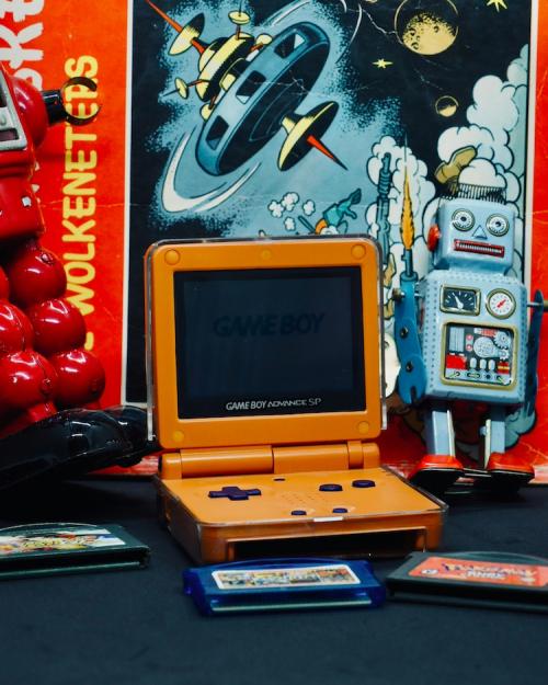 		small orange handheld video game player with a spaceship backdrop
	