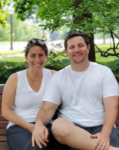 		two people on a park bench
	