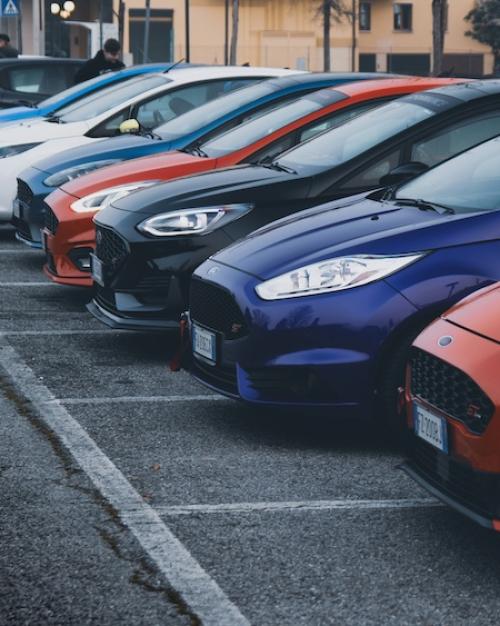 Row of cars for sale in a parking lot