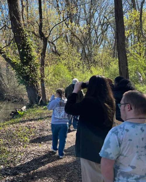 		Several people on a path in the woods
	