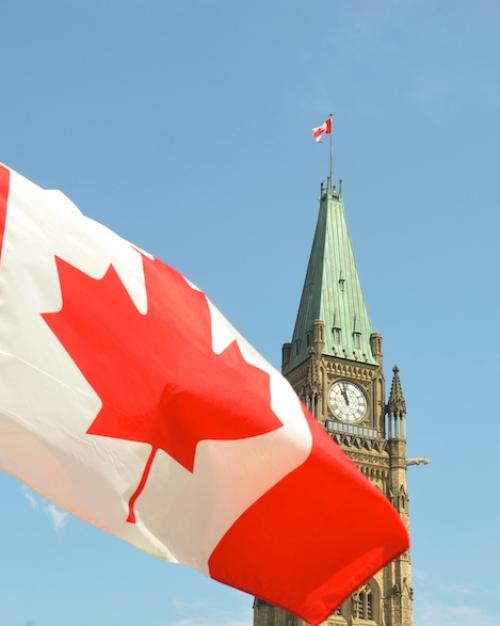 		Canada's red and white flag with Ottawa's Peace Tower in the background
	