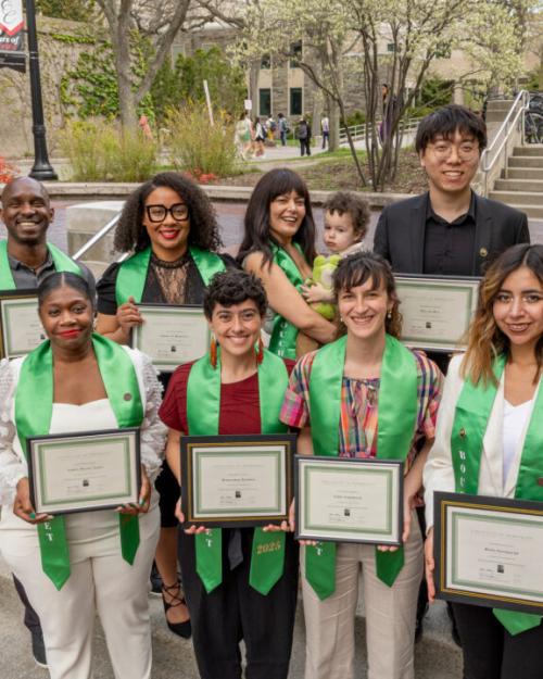 		Eight people wearing green academic stoles (plus one baby)
	