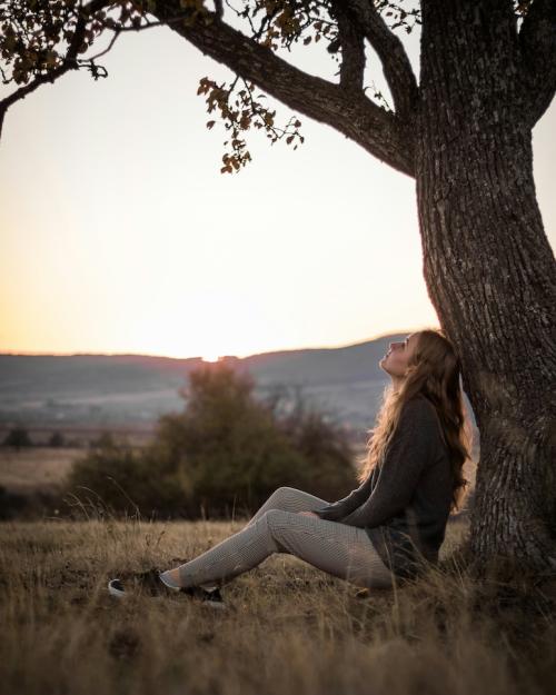 		Person sitting under a tree
	