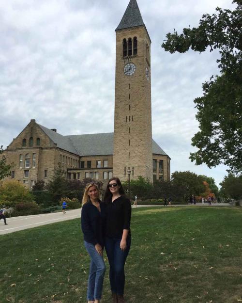two people standing near McGraw Clock Tower