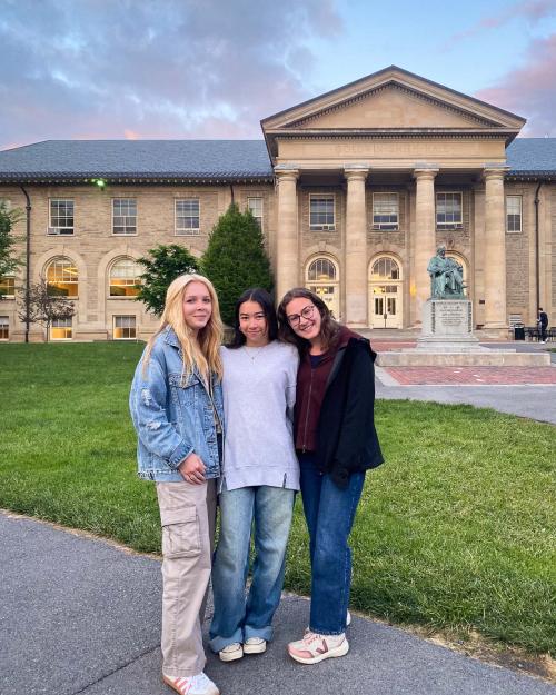 three people standing outside