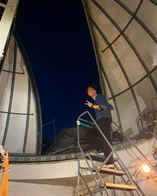 person near a telescope