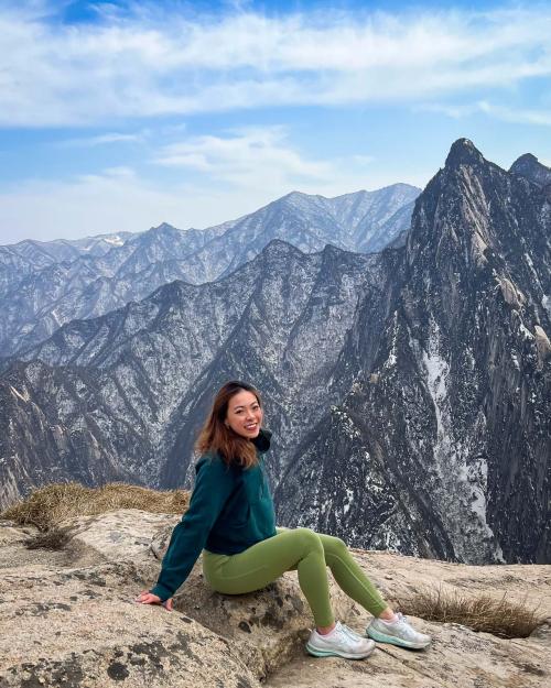 person sitting with mountains in the background