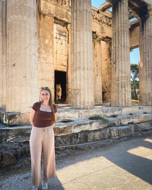 person standing by an ancient ruin