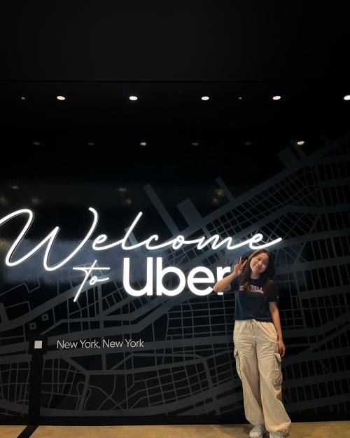 person standing in front of sign reading "Welcome to Uber"