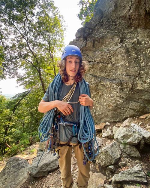 person holding climbing gear