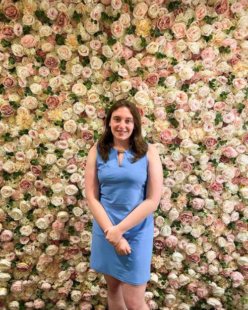 person standing in front of background with flowers